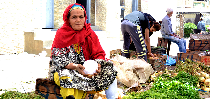 Ambulant merchant from Kenitra holding the Sun King Pro 2 solar lantern provided to her.