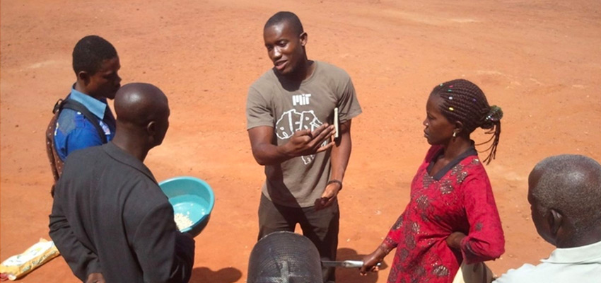 Kwami Williams (center, in an MIT shirt) at a Moringa training workshop in Techiman, Ghana in February 2013. He is explaining the technologies to process Moringa seeds in our effort to help farmers generate income from this underutilized component of the Moringa tree. Phot: Courtesy MIT D-Lab