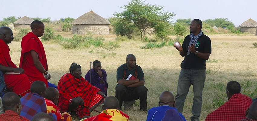 An employee of Global Cycle Solutions introduces a solar lamp to villagers in rural Tanzania. Credits: Courtesy of Global Cycle Solutions 