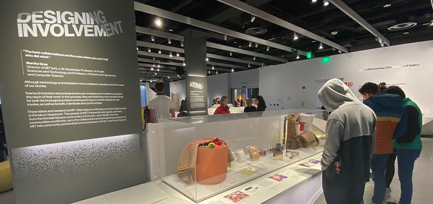 MIT Museum visitors viewing the D-Lab exhibits, which include a clay pot cooler,  a Saathi pad, biomass briquetting technlogies, and the SurgiBox. Photo: MIT D-Lab