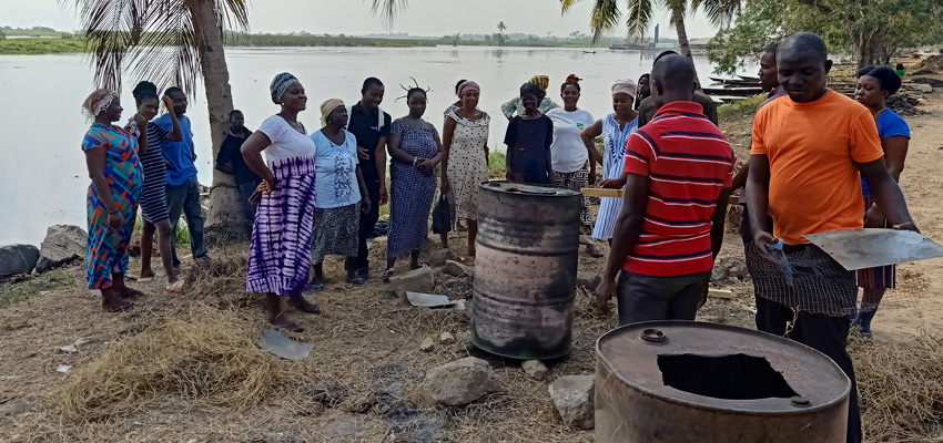 Community members making charcoal from harvested aquatic weeds from the Volta River basin during a visit by MIT D-Lab researchers and students. Ghana, 2024.