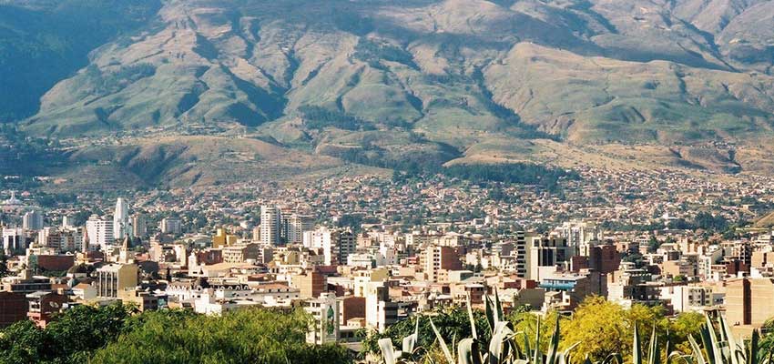 Arial view of a city in a lush green valley.