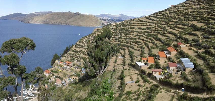 View of town on terraced hillside overlooking a body of water.