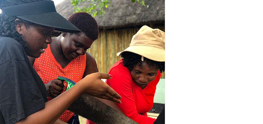 Pelo Kamwi instructing Gabaeme Katunda on how to use a saw during the Build-It project to make a maize sheller.