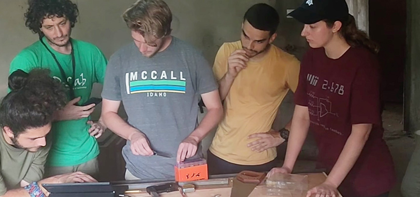 five people looking at a table