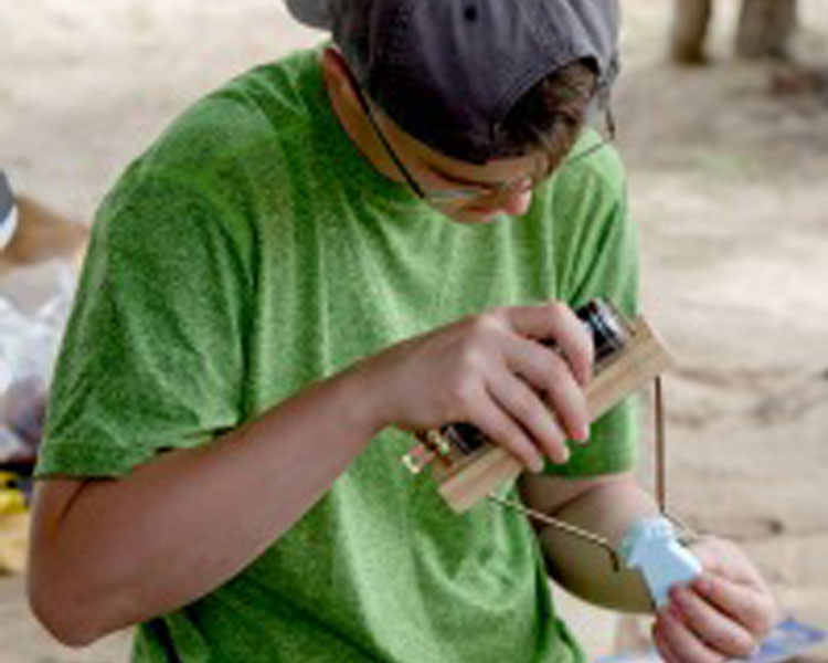 Cady '18 using a hot wire cutter to make a foam piece.