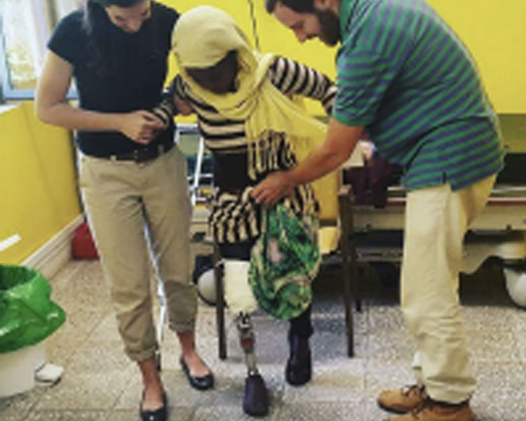 Members of the SmartSocket team working with a patient.