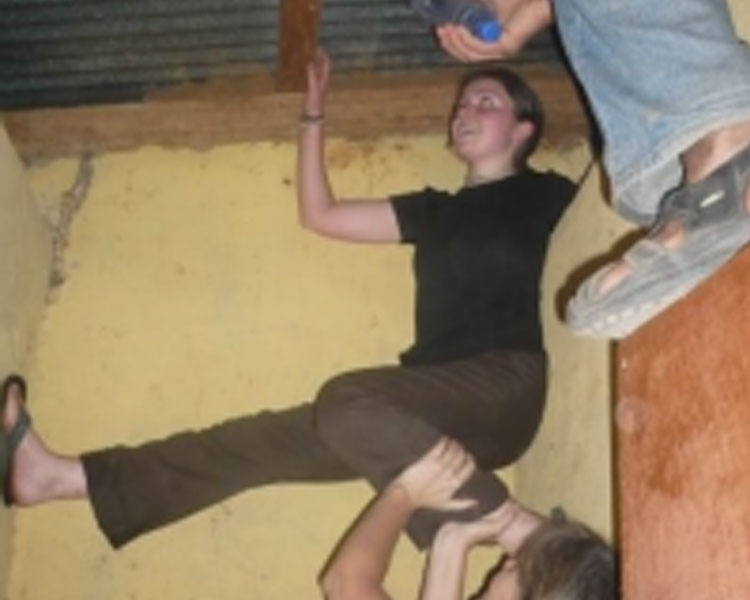 Installing water bottle lightbulbs with Amy Smith (bottom) and Kofi Taha (sandal alove right!) in Ghana.