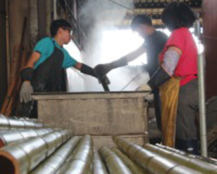 Learning about the bamboo curing process to remove sugars and pests from the culms.