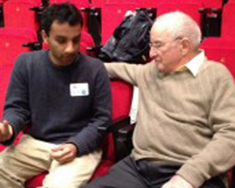 Keynote speaker Paul Polak (right) speaks with conference attendee