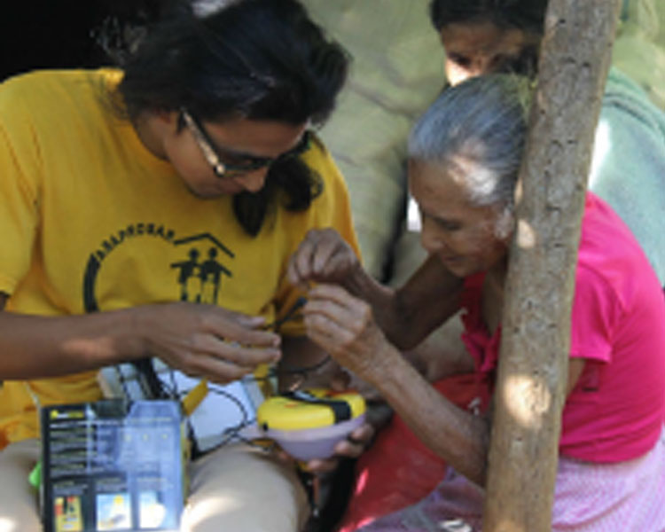 ASAPROSAR staff Geovany Moreno demonstrating a solar lantern to resident of El Sauce. 