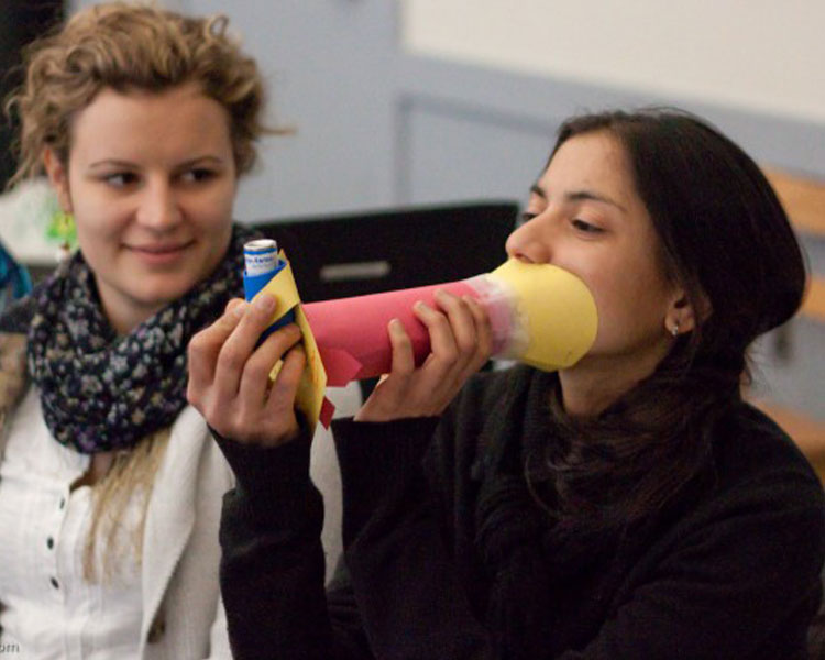 A paper spacer used to slow the flow rate of an inhaler allowing children to more easliy inhale the medicine.