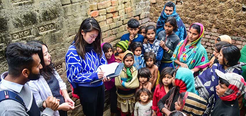 Kids gathering during an interview with a smallholder farmer.