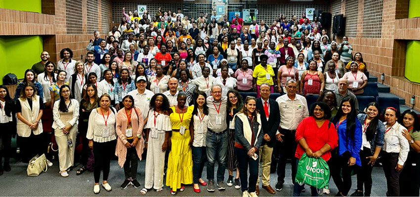 Large group of 40 or more men and women standing in rows.