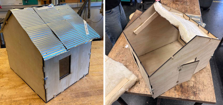 Two models of a simple house on a workbench, one with the roof partially uncovered.